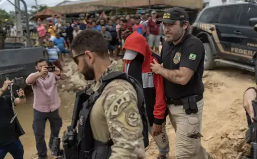 a man is escorted by the police