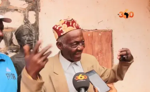 Man gestures while speaking to reporters in microphone