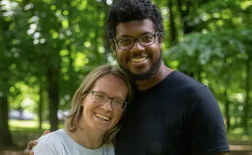 A man and woman pose happily, together