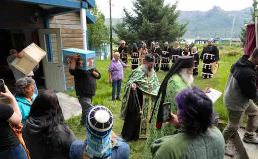 A man carries a small blue coffin at a Native American ceremony