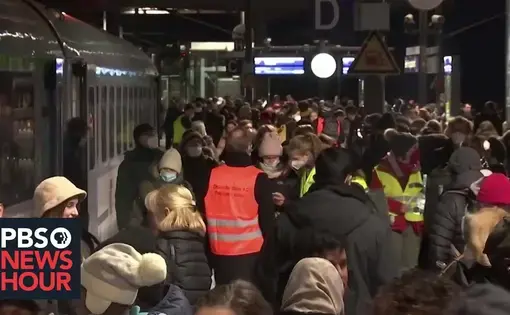 youtube thumbnail shows people crowded at a train station