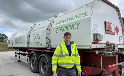 Stephen Nolan, the general manager of Green Generation standing with one the plants heavy goods vehicles. Image by Niamh McAuliffe. Ireland, 2022.