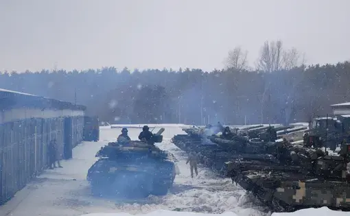 A tank trundling through a curtain of exhaust