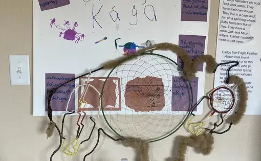 A kid's school project, written in Lakota, features a buffalo model and a dreamcatcher