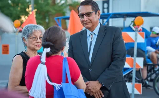 Politician speaks with constituents at a public event