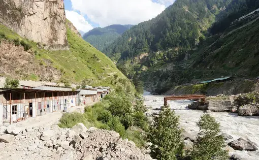 Shelters built on edge of a sparkling river