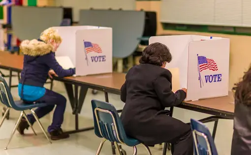 people vote at a polling booth on U.S. election day