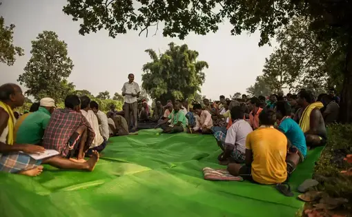 People gather on a tarp