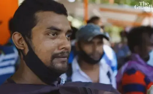 A man cries as migrant laborers are forced to leave the cities for COVID lockdown in India. From The Guardian documentary "The Great Abandonment"