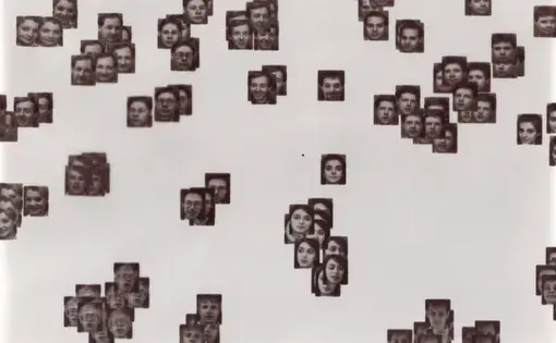 A laptopogram based on a neutral background and populated by scattered squared portraits, all monochromatic, grouped according to similarity. The groupings vary in size, ranging from single faces to overlapping collections of up to twelve. The facial expressions of all the individuals featured are neutral, represented through a mixture of ages and genders.