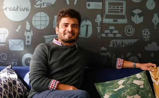 Kumar Sambhav Shrivastava posing on a sofa.