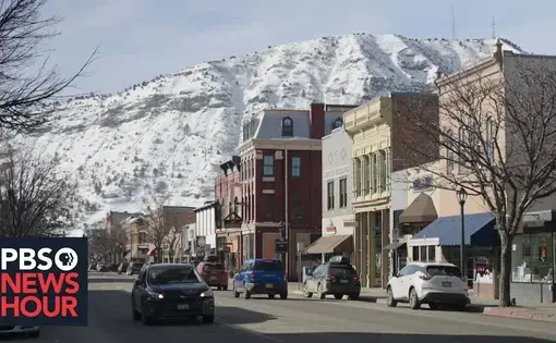 A small downtown against a snowy mountain