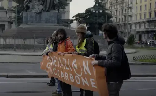activists hold a sign for Ultima Generazione