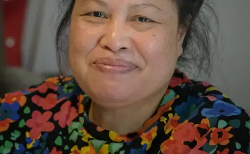 Portrait of an older woman with a floral print dress.