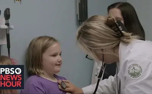 A doctor uses a stethoscope on a child patient during a checkup.