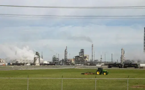 A large chemical plant emits steam.