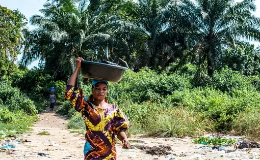 a woman carrying a bucket