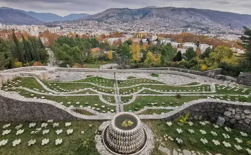 A view from above showing the patterns of laid stones on grass at the Partisan Necropolis in Mostar.