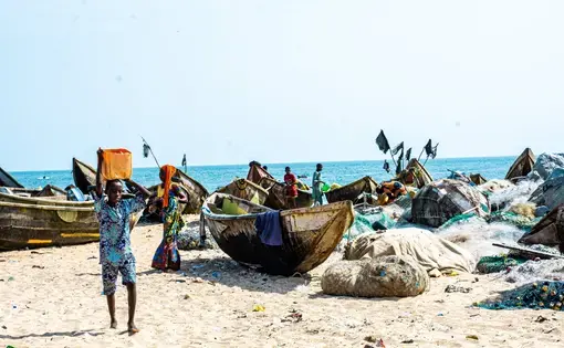 Fishermen prepare to fish on the seashore.