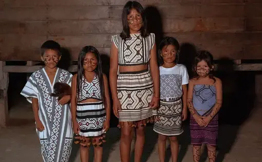 Children from the isolated tribes stand together dressed in their traditional outfits.