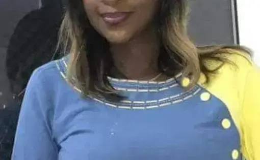 A woman in a color block blue and yellow dress.