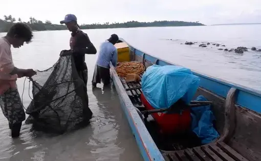 fishermen on a fishing boat with a net