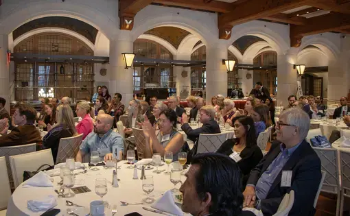 The audience claps for the panelists at the Pulitzer Center lunch