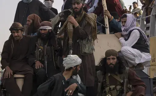 A group of Taliban fighters sit on a truck