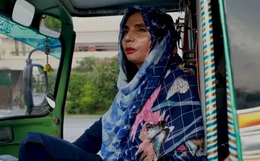 A women in the driver's seat in a rickshaw