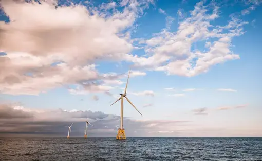 Alternative renewable energy wind turbines off shore near Rhode Island. Image by Cavan-Images/Shutterstock.