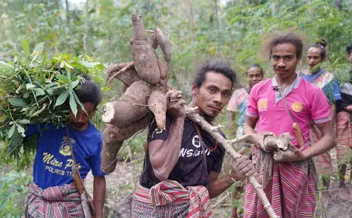 a man carries something that he plantes