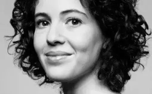 Black and white photo of a woman with curly dark hair