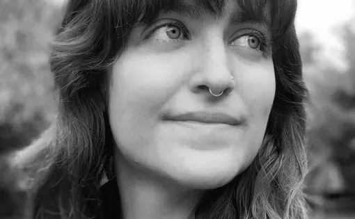 Black and white image of a woman with long hair and bangs