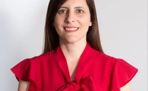 a woman with long dark straight hair wearing a bright red blouse