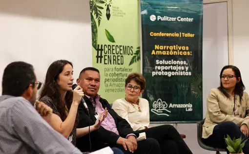 All five panelists at the front of the room
