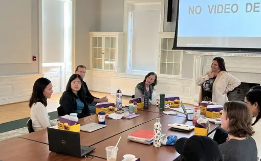 Journalists and students talk around a classroom table