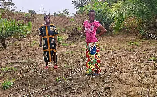 Two women standing akimbo.