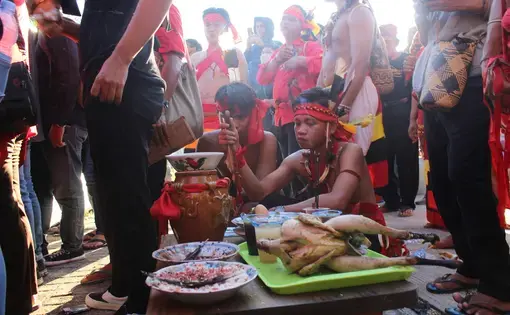 Two young boys sit in a ritual.