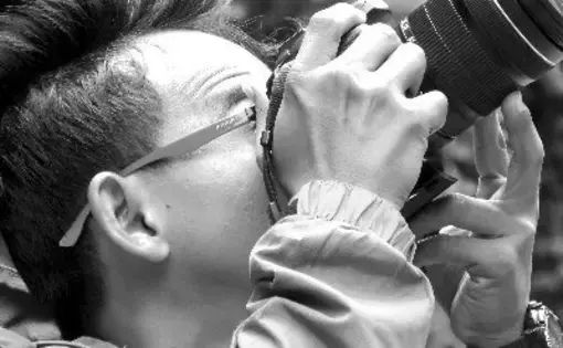 Photo of Zulkarnaini Masry capturing a photograph with his camera.