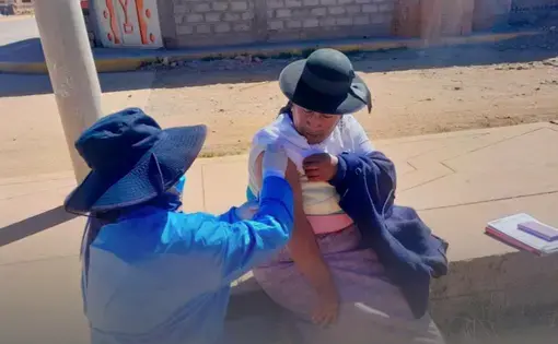 A woman recieves a vaccine shot, Peru