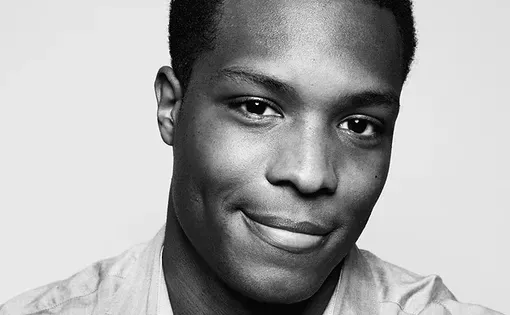 Headshot of Josiah Bates wearing a light button down shirt