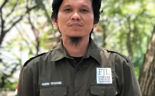 Fendra Tryshanie stands clad in military green shirt.