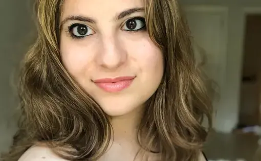 A woman with shoulder-length brown hair