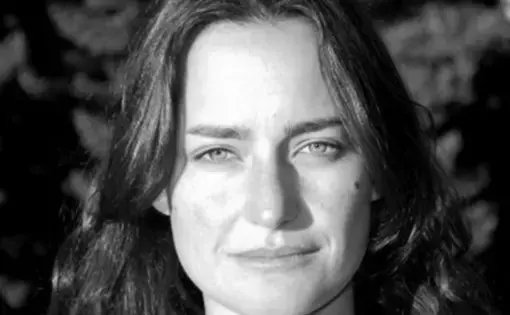 Black and white headshot of a woman with long dark hair