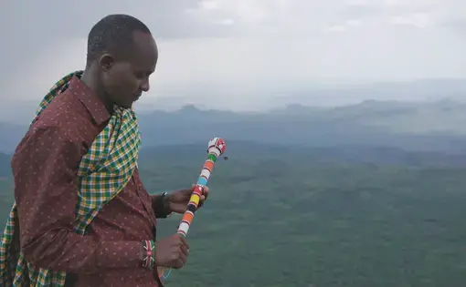 Still from the battle for Laikipia of a man holding a stick