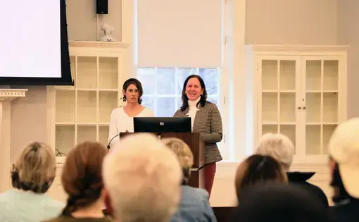 Two people at a podium seen from the audience