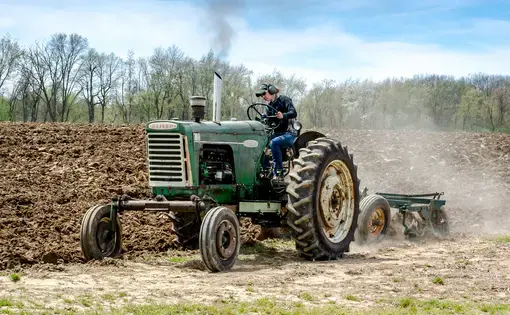 April 22, 2017 Buchanan MI USA; A farmer on a large antique tractor participates in the plow days event in southwest Michigan.