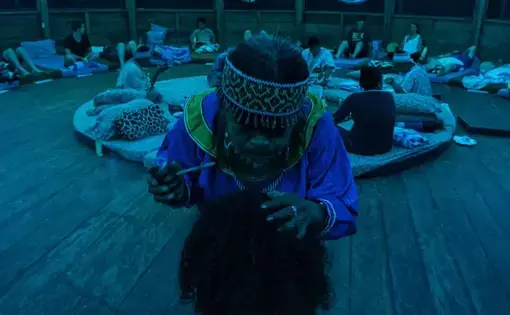 Before each ceremony, Justina Cerrano blows tobacco smoke over each of the participants to give them protection.