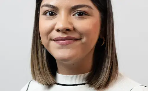 Headshot of Alejandra Martinez wearing a white top