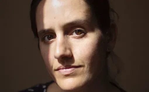 Headshot of Danielle wearing a navy pattered shirt